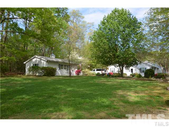 7000 Leesville Road Raleigh, NC 27613 - Photo 2 of 24 a front view of a house with a garden