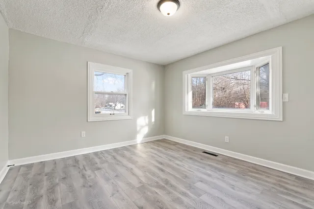 a view of room with window and hardwood floor
