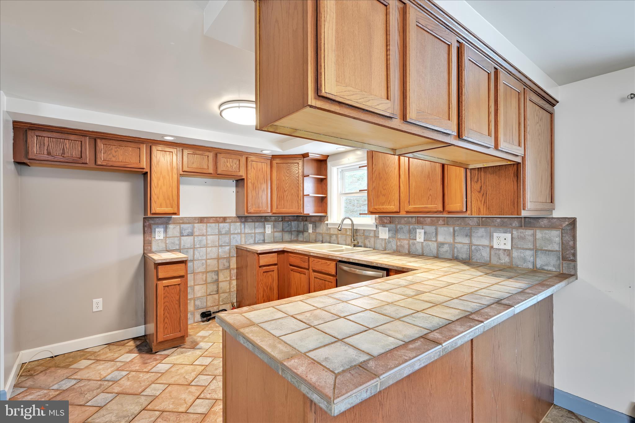424 Fearnot Road Sacramento, PA 17968 - Photo 12 of 44 a kitchen with stainless steel appliances granite countertop a sink and cabinets