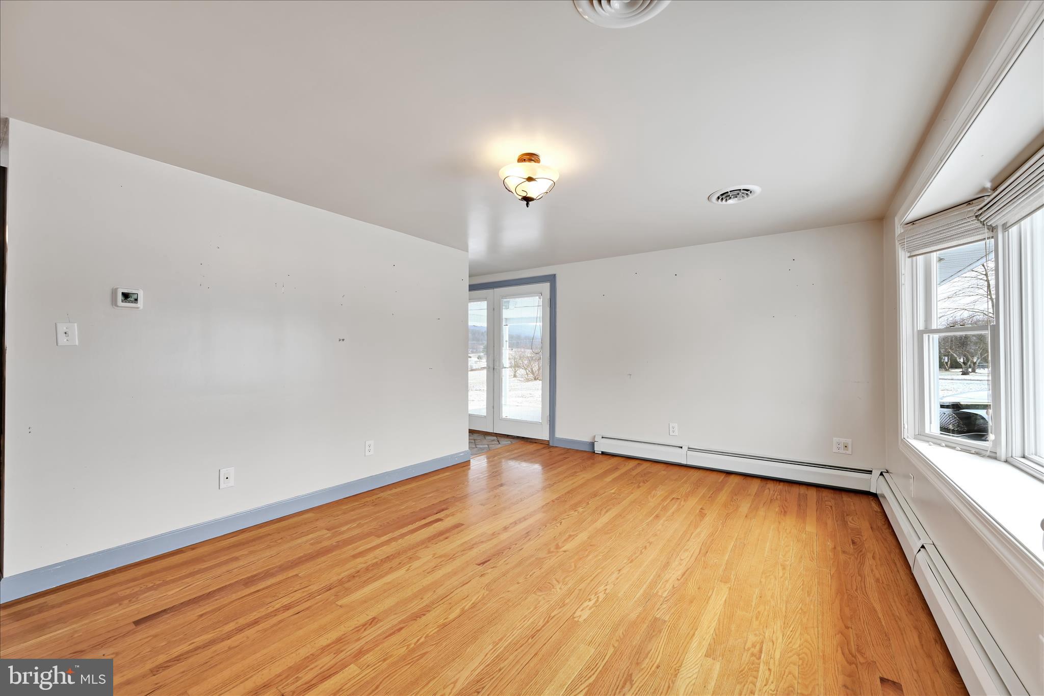424 Fearnot Road Sacramento, PA 17968 - Photo 10 of 44 wooden floor in an empty room with a window