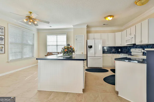 a kitchen with a sink and refrigerator
