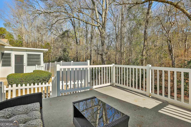 a view of a wooden chairs and bench in the deck