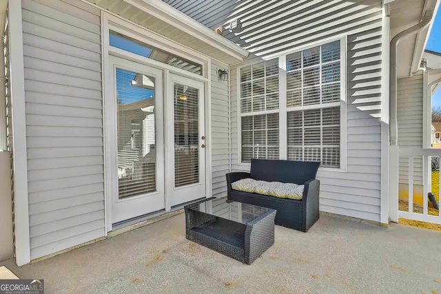 a view of a patio with couches and a table and chairs