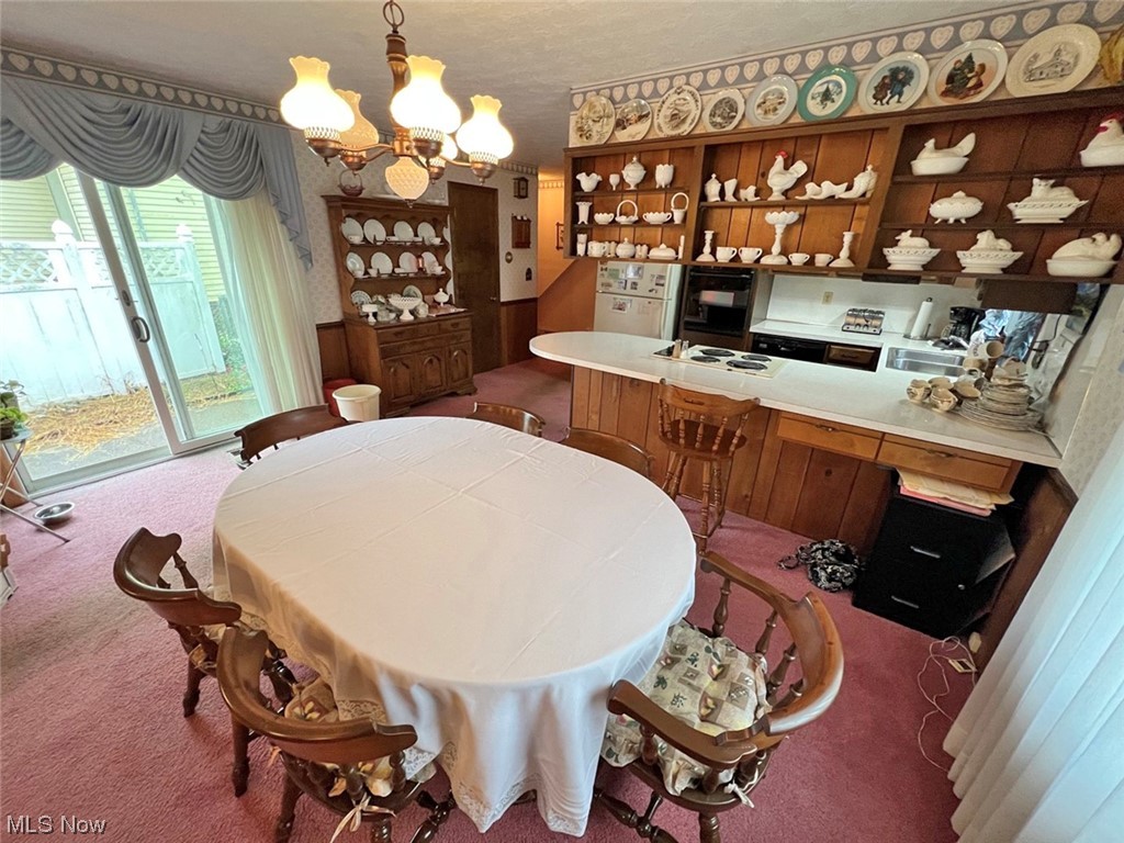 918 Amherst Road Northeast Massillon, OH 44646 - Photo 11 of 31 Carpeted dining space with a chandelier