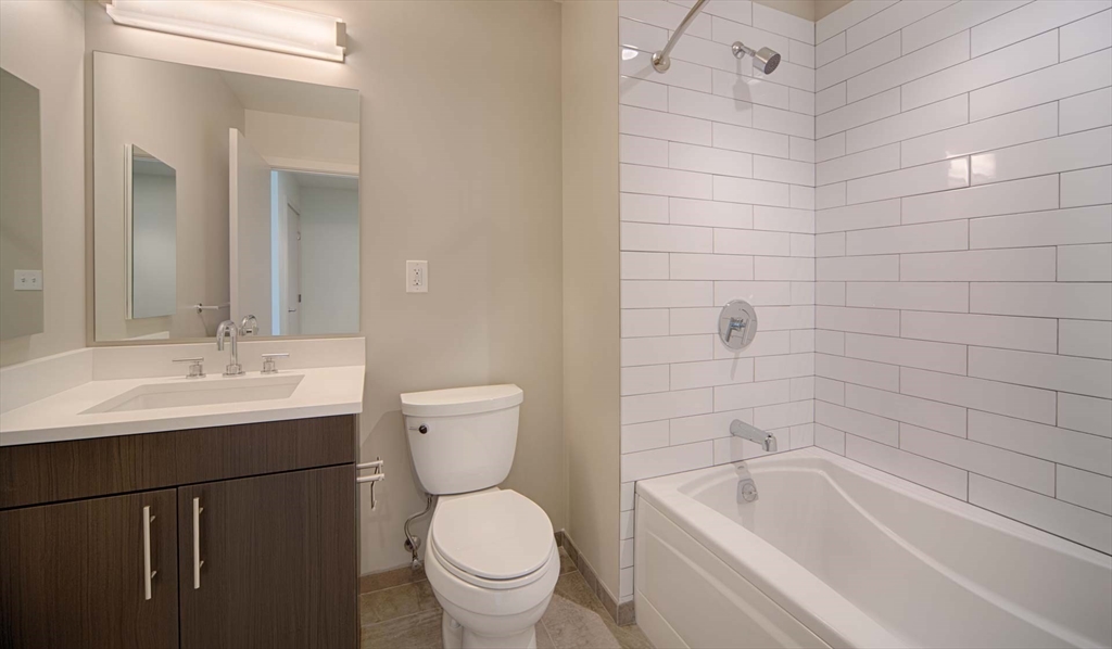 1 Canal Street, Unit 738 Boston, MA 02114 - Photo 6 of 12 a bathroom with a sink a toilet and bathtub