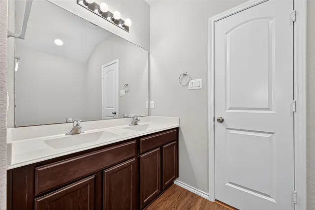 a bathroom with a double vanity sink and a mirror