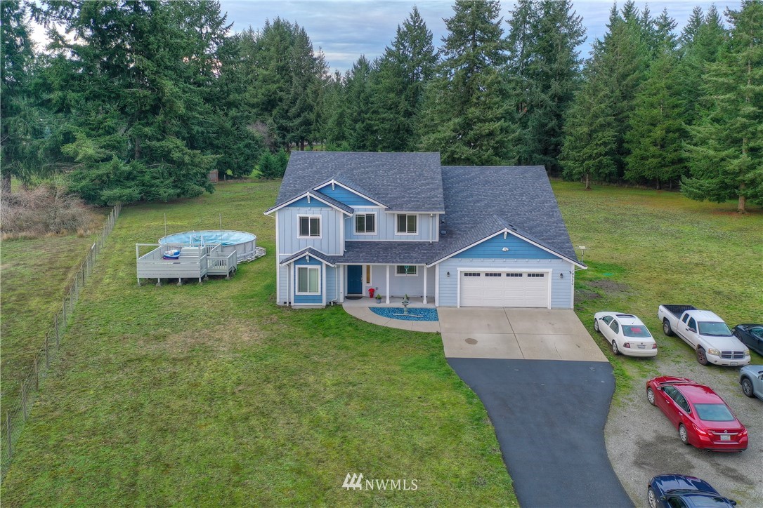 19520 Grand Mound Way Southwest Rochester, WA 98579 - Photo 2 of 34 an aerial view of a house with swimming pool garden view and trees