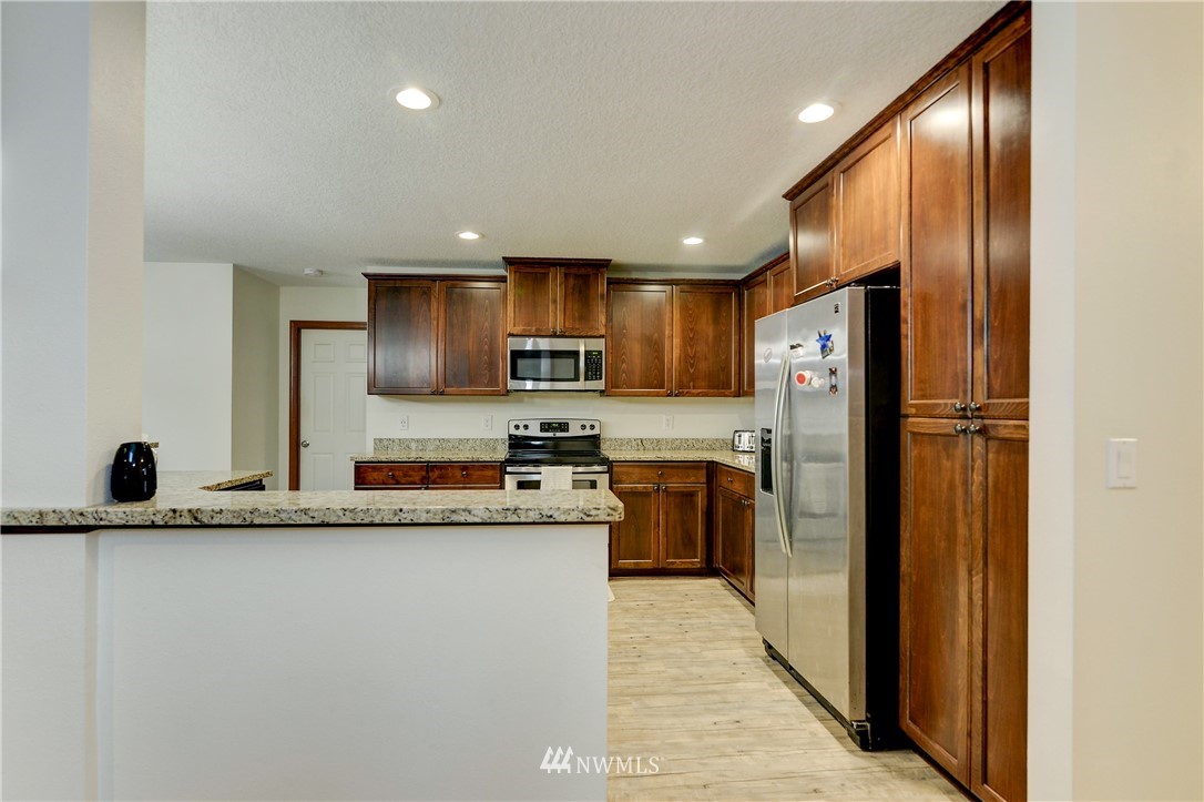 19520 Grand Mound Way Southwest Rochester, WA 98579 - Photo 11 of 34 a kitchen with refrigerator and cabinets