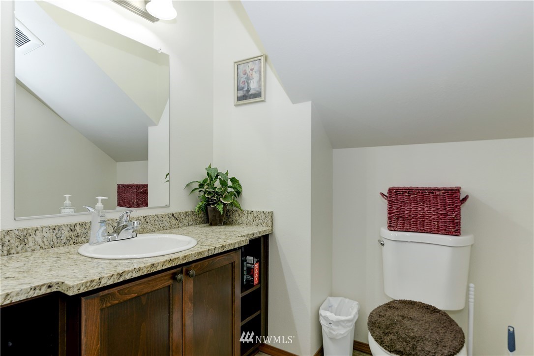 19520 Grand Mound Way Southwest Rochester, WA 98579 - Photo 14 of 34 a bathroom with a granite countertop sink and a mirror with toilet