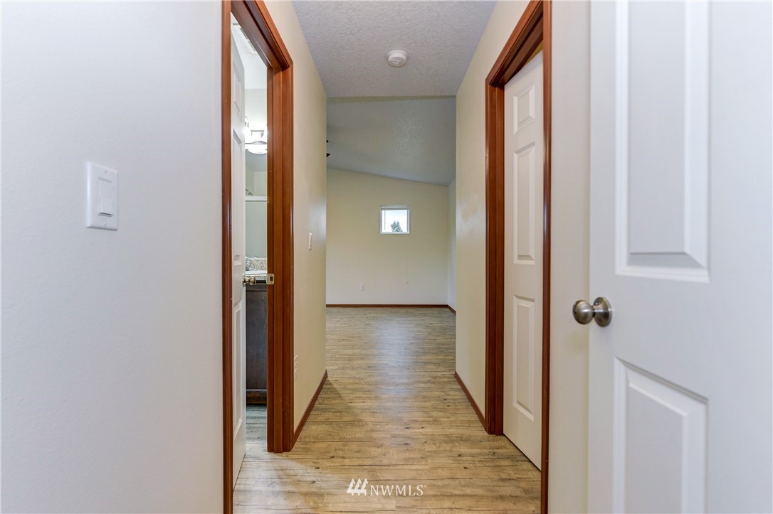 19520 Grand Mound Way Southwest Rochester, WA 98579 - Photo 19 of 34 a view of a hallway with wooden floor and staircase