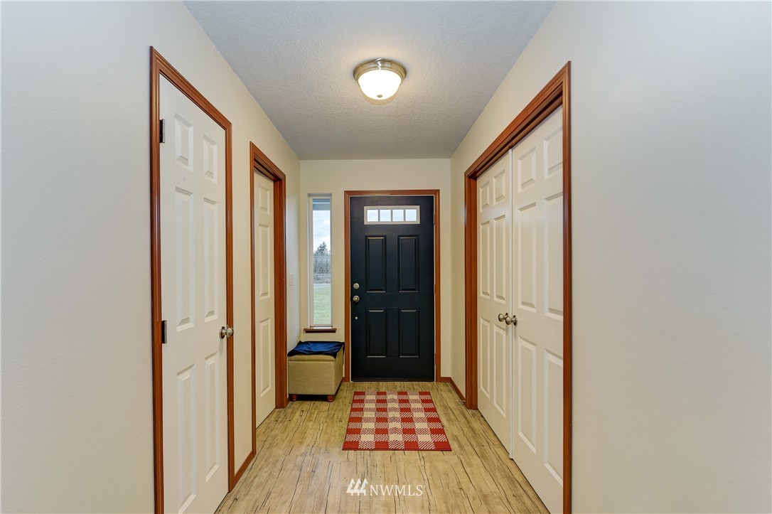 19520 Grand Mound Way Southwest Rochester, WA 98579 - Photo 3 of 34 a view of a hallway with wooden floor and a bathroom