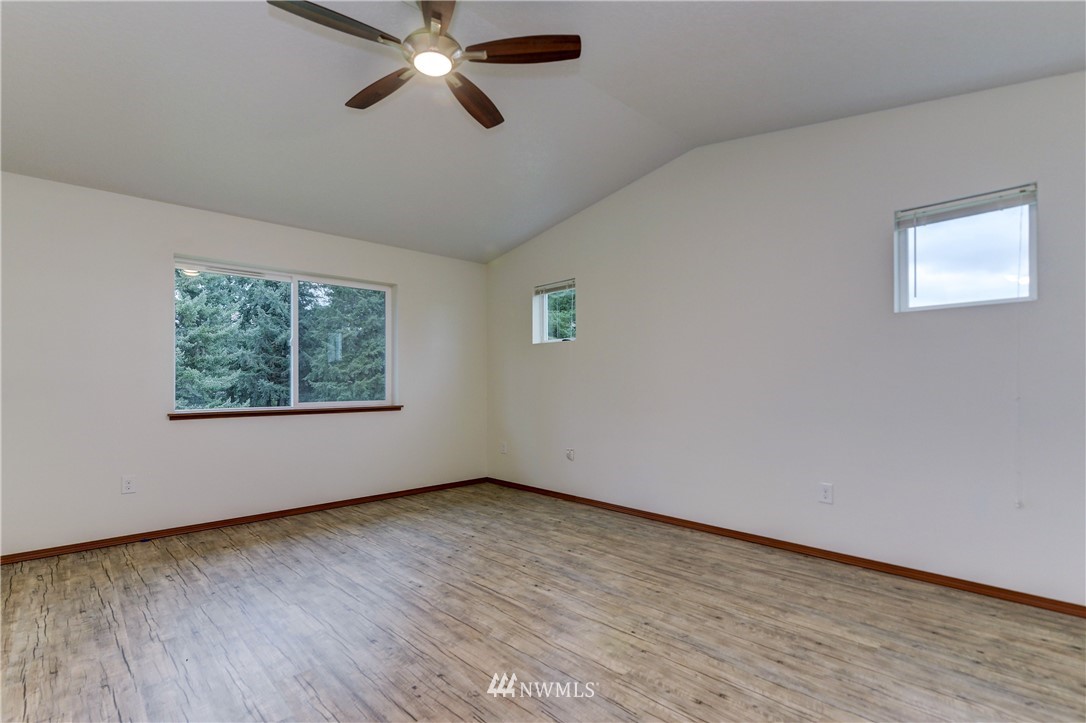 19520 Grand Mound Way Southwest Rochester, WA 98579 - Photo 22 of 34 a view of an empty room with wooden floor and a window