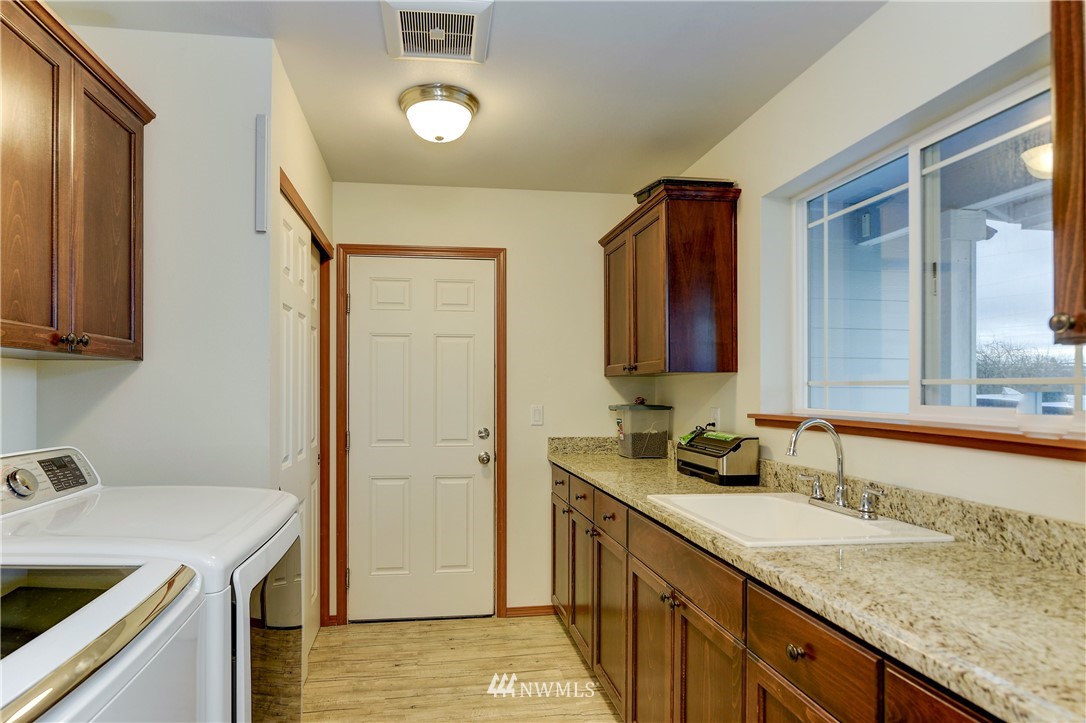 19520 Grand Mound Way Southwest Rochester, WA 98579 - Photo 5 of 34 a bathroom with a granite countertop sink and a mirror