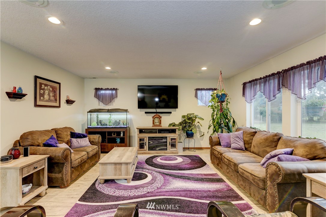 19520 Grand Mound Way Southwest Rochester, WA 98579 - Photo 7 of 34 a living room with furniture and a flat screen tv