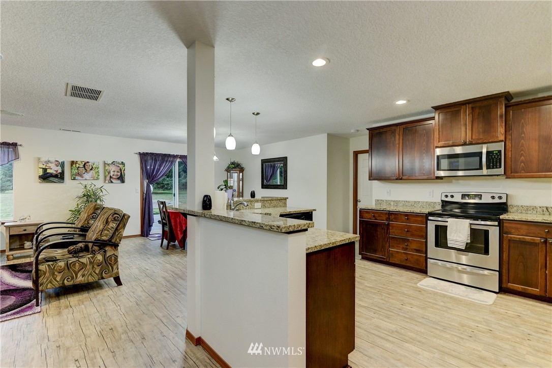 19520 Grand Mound Way Southwest Rochester, WA 98579 - Photo 10 of 34 a kitchen with granite countertop lots of counter top space and stainless steel appliances