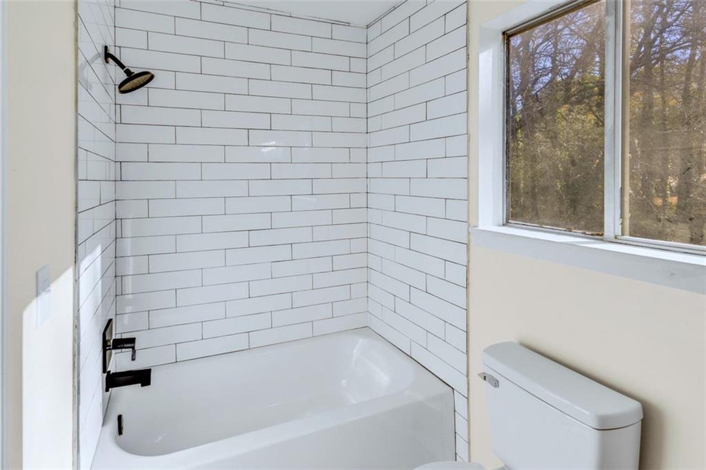 6695 Cedar Hurst Trail Atlanta, GA 30349 - Photo 14 of 24 a bathroom with a bathtub