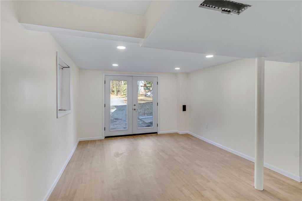 6695 Cedar Hurst Trail Atlanta, GA 30349 - Photo 22 of 24 a view of an empty room with wooden floor and windows