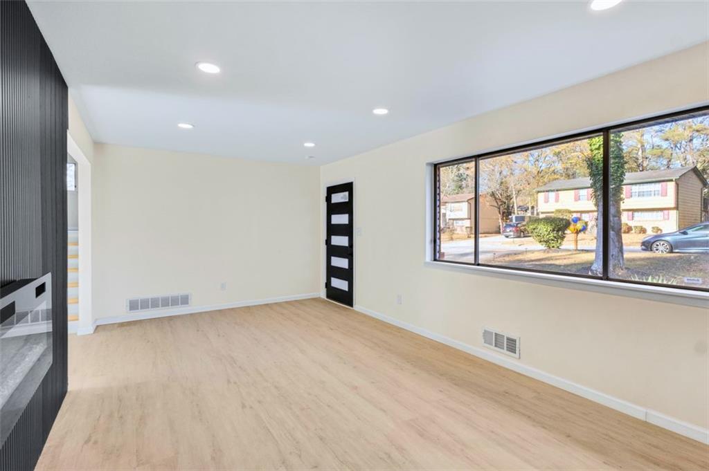 6695 Cedar Hurst Trail Atlanta, GA 30349 - Photo 4 of 24 wooden floor in an empty room with a window
