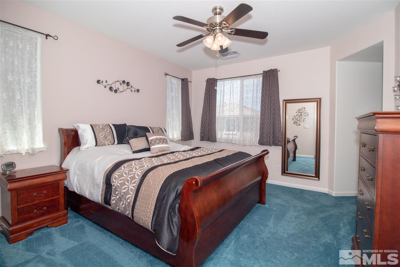 1945 Hope Valley Drive Reno, NV 89521 - Photo 15 of 22 a bedroom with a large bed and a chandelier