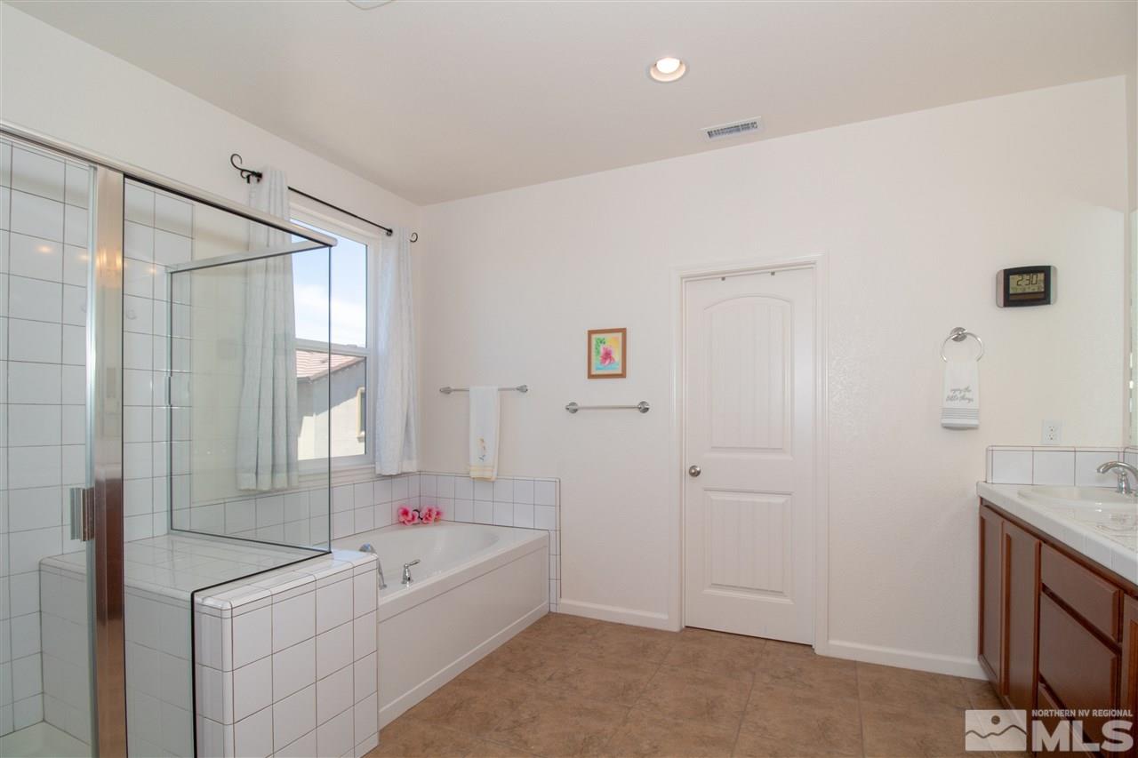 1945 Hope Valley Drive Reno, NV 89521 - Photo 17 of 22 a bathroom with a tub sink and a mirror