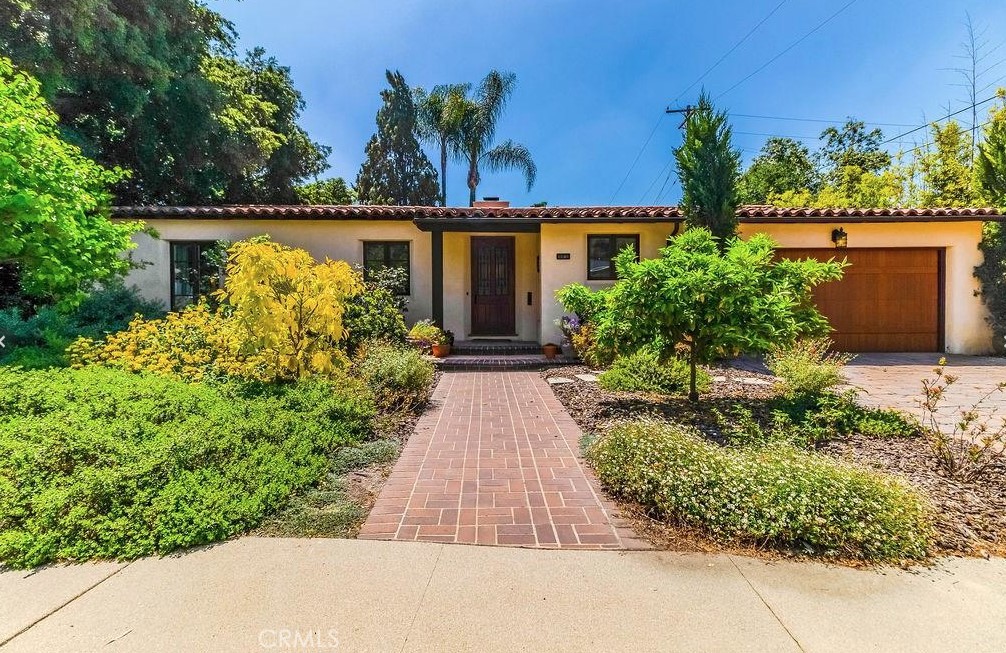 an aerial view of a house with a yard and potted plants