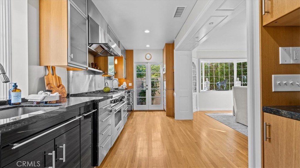460 University Circle Claremont, CA 91711 - Photo 14 of 41 a kitchen with granite countertop a sink a counter top space and stainless steel appliances