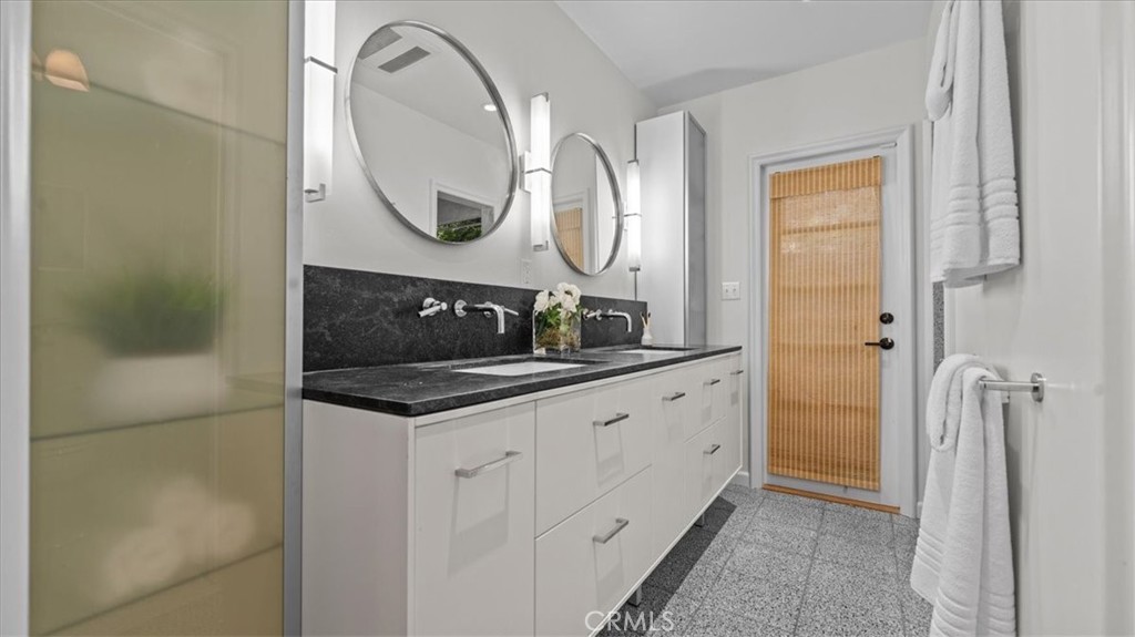 460 University Circle Claremont, CA 91711 - Photo 21 of 41 a bathroom with a granite countertop sink a mirror and a shower