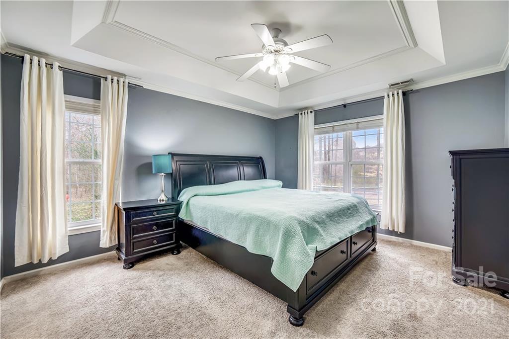 3795 Kennedy Road Gastonia, NC 28056 - Photo 14 of 32 a spacious bedroom with a bed and a chandelier