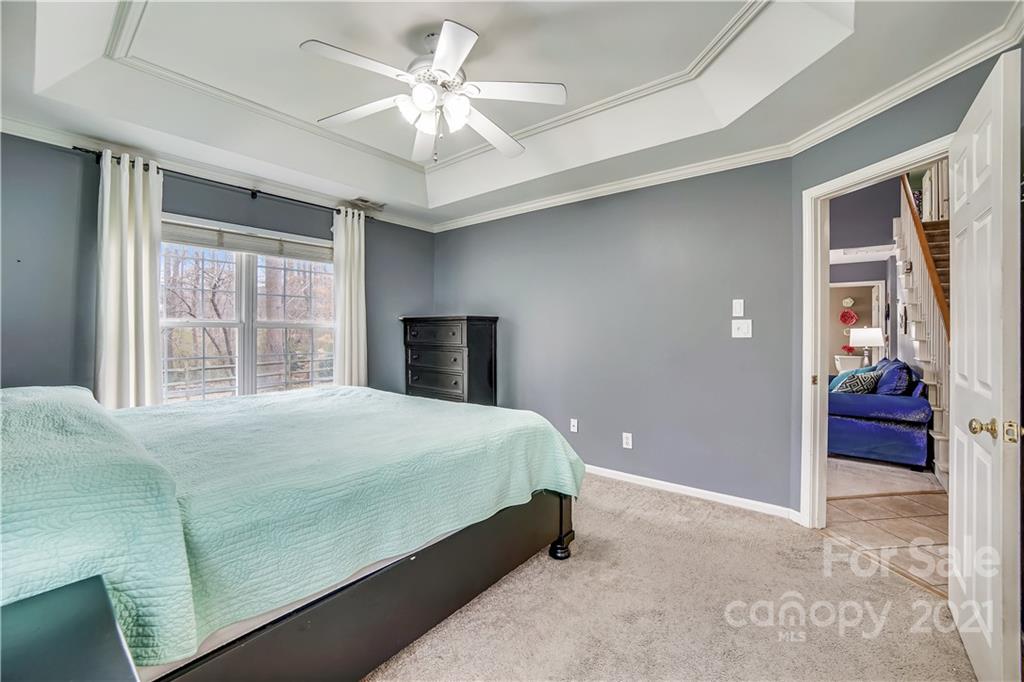 3795 Kennedy Road Gastonia, NC 28056 - Photo 15 of 32 a bedroom with a large bed and a chandelier