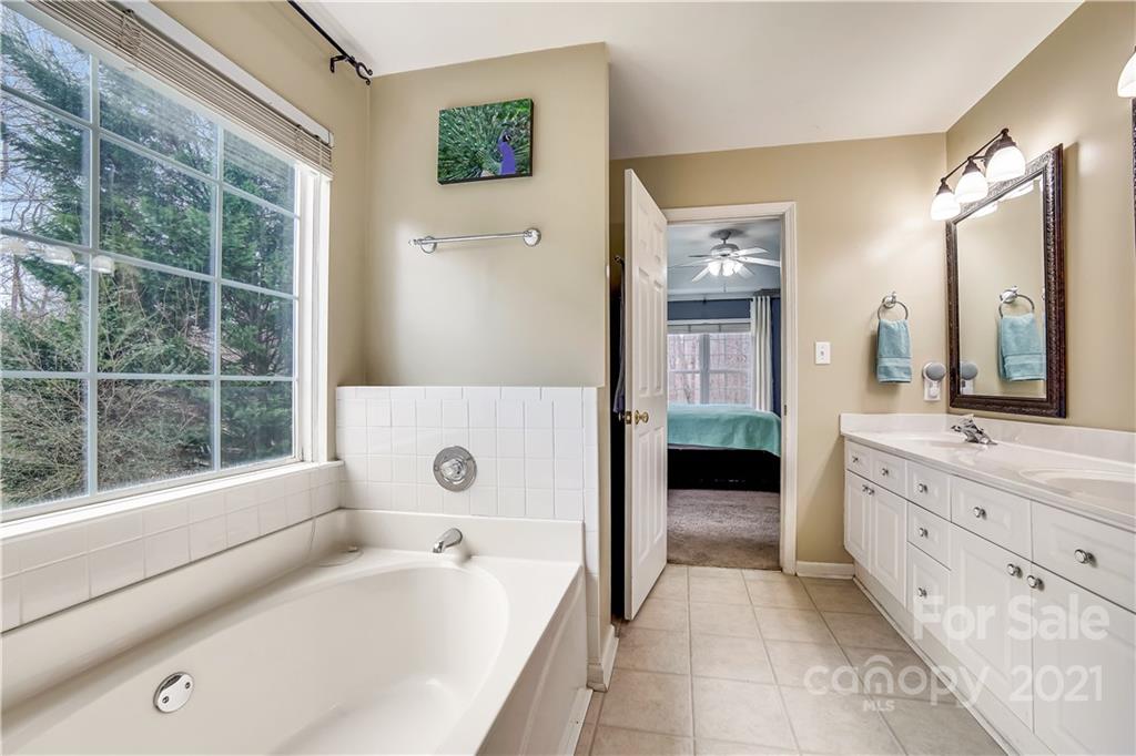 3795 Kennedy Road Gastonia, NC 28056 - Photo 17 of 32 a bathroom with a bathtub sink and mirror