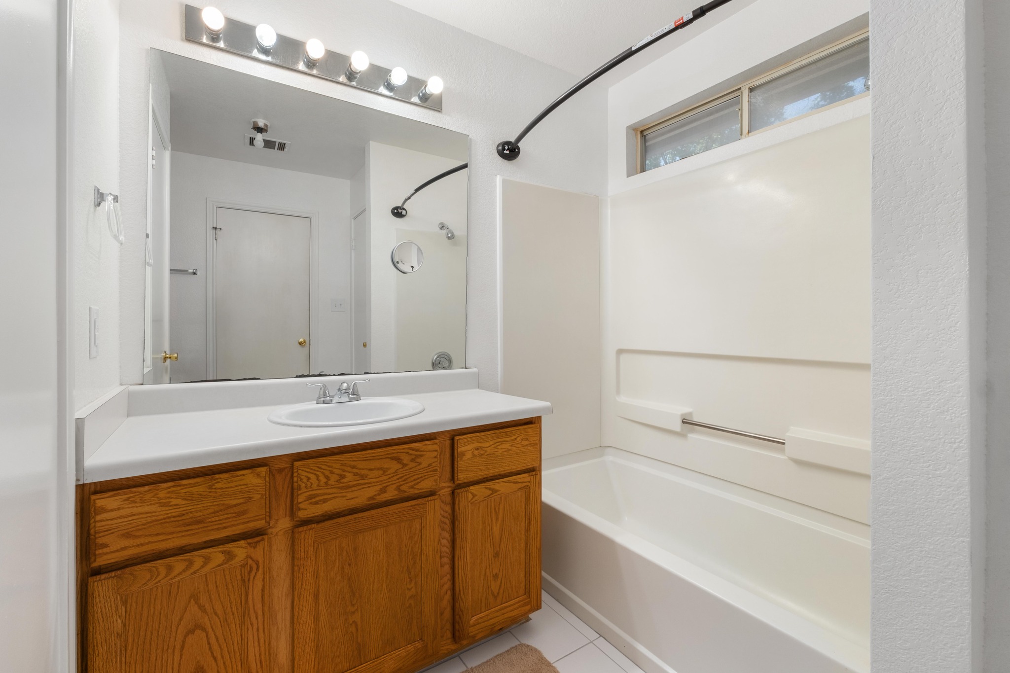 1184 Waller Street Austin, TX 78702 - Photo 9 of 19 a bathroom with a granite countertop sink a mirror and a bathtub