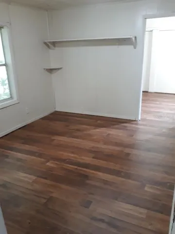 a view of a room with wooden floor