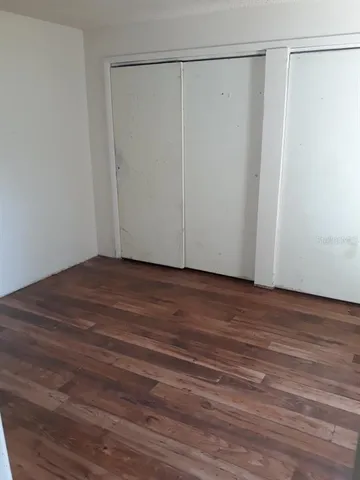 a view of a room with wooden floor