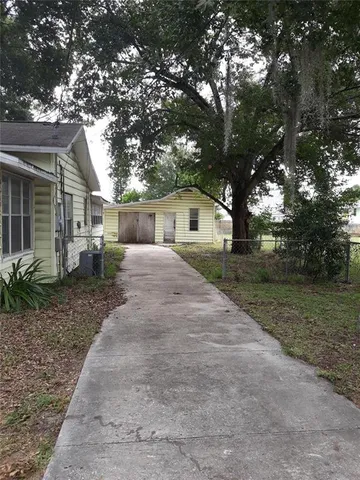 a view of house with trees in front of it