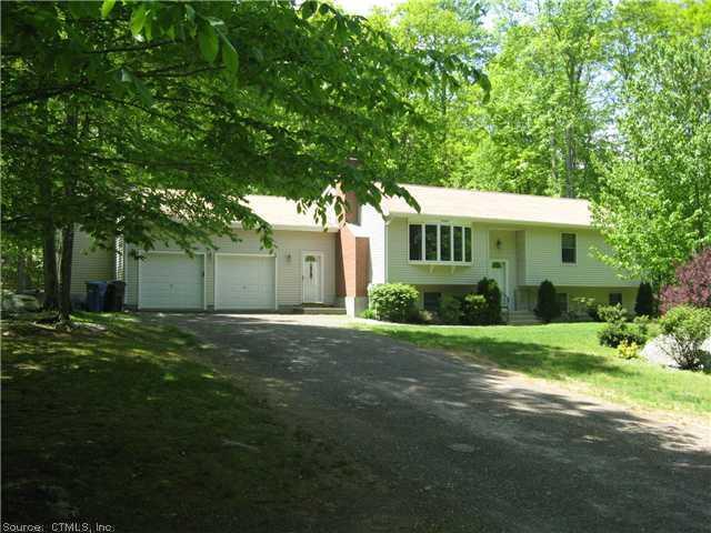 823 Toby Hill Road Westbrook, CT 06498 - Photo 1 of 1 a front view of a house with a garden and trees