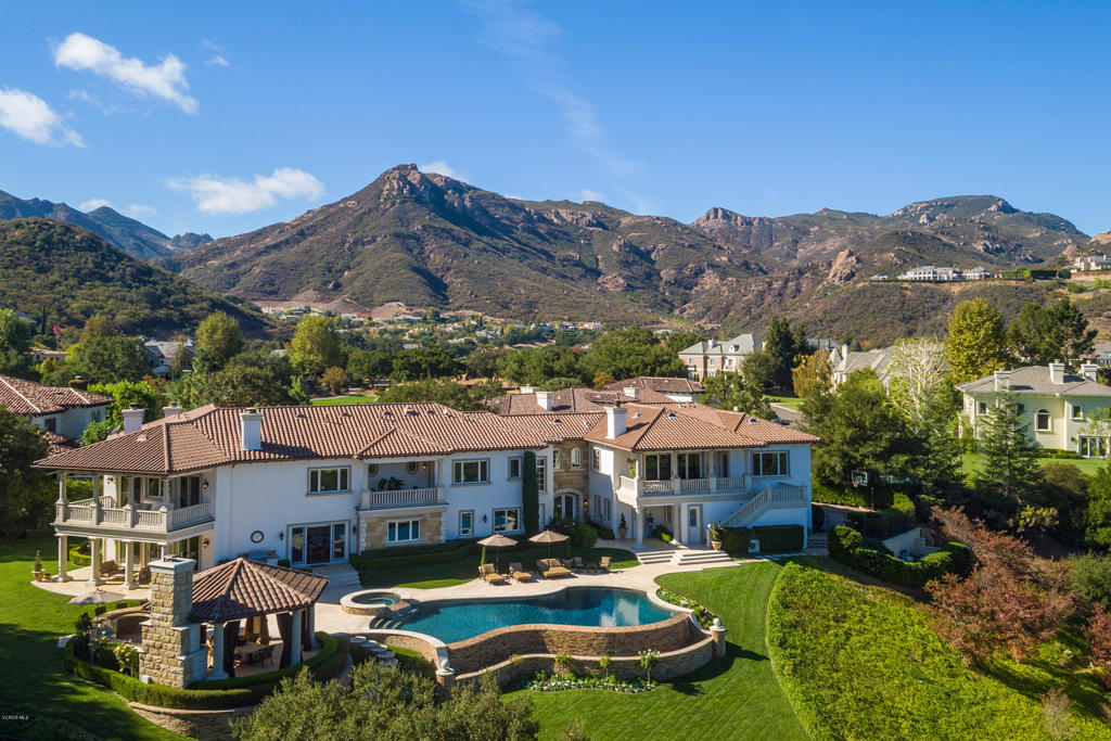 a aerial view of a house with swimming pool and a yard