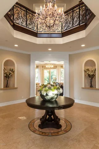 a living room with furniture fireplace and a large window