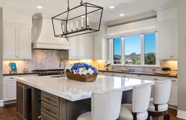 a view of a dining room with furniture and chandelier