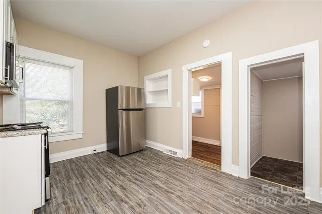 a kitchen with a refrigerator and a stove top oven