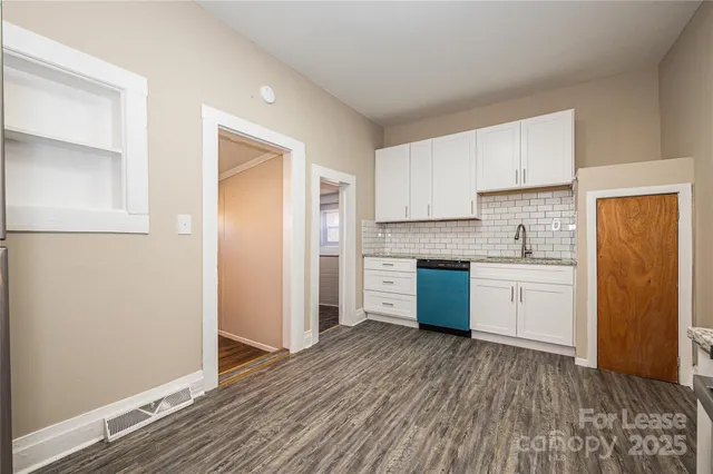 a kitchen with a refrigerator sink and cabinets