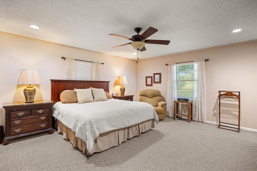 17305 Highway 281 Hico, TX 76457 - Photo 14 of 28 a bedroom with bed and window
