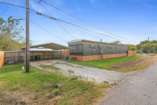 a view of a house with a backyard