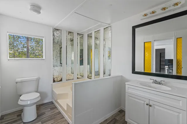 a bathroom with a sink toilet and mirror