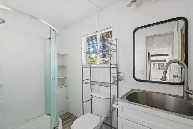 a bathroom with a toilet a sink and mirror