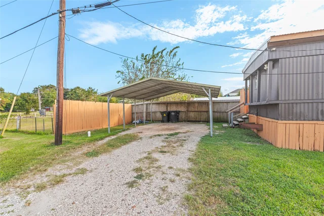 a view of a backyard with a garden and deck