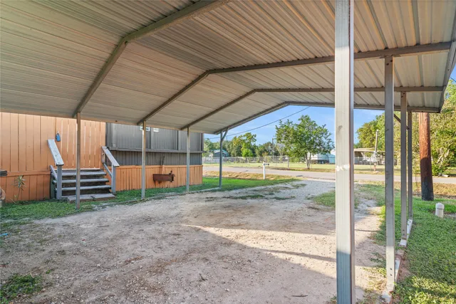 a view of a backyard with wooden fence and a porch