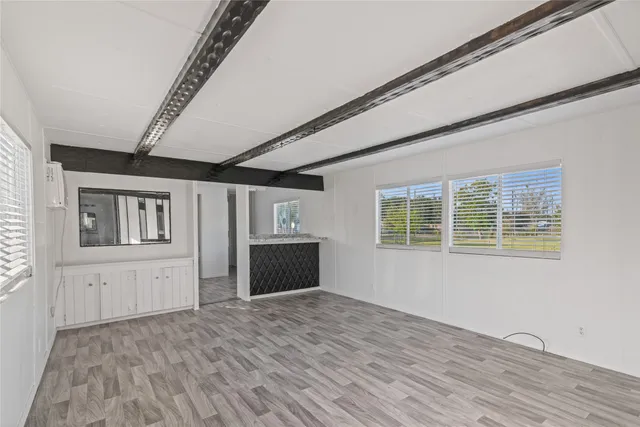 a view of empty room with wooden floor and cabinet