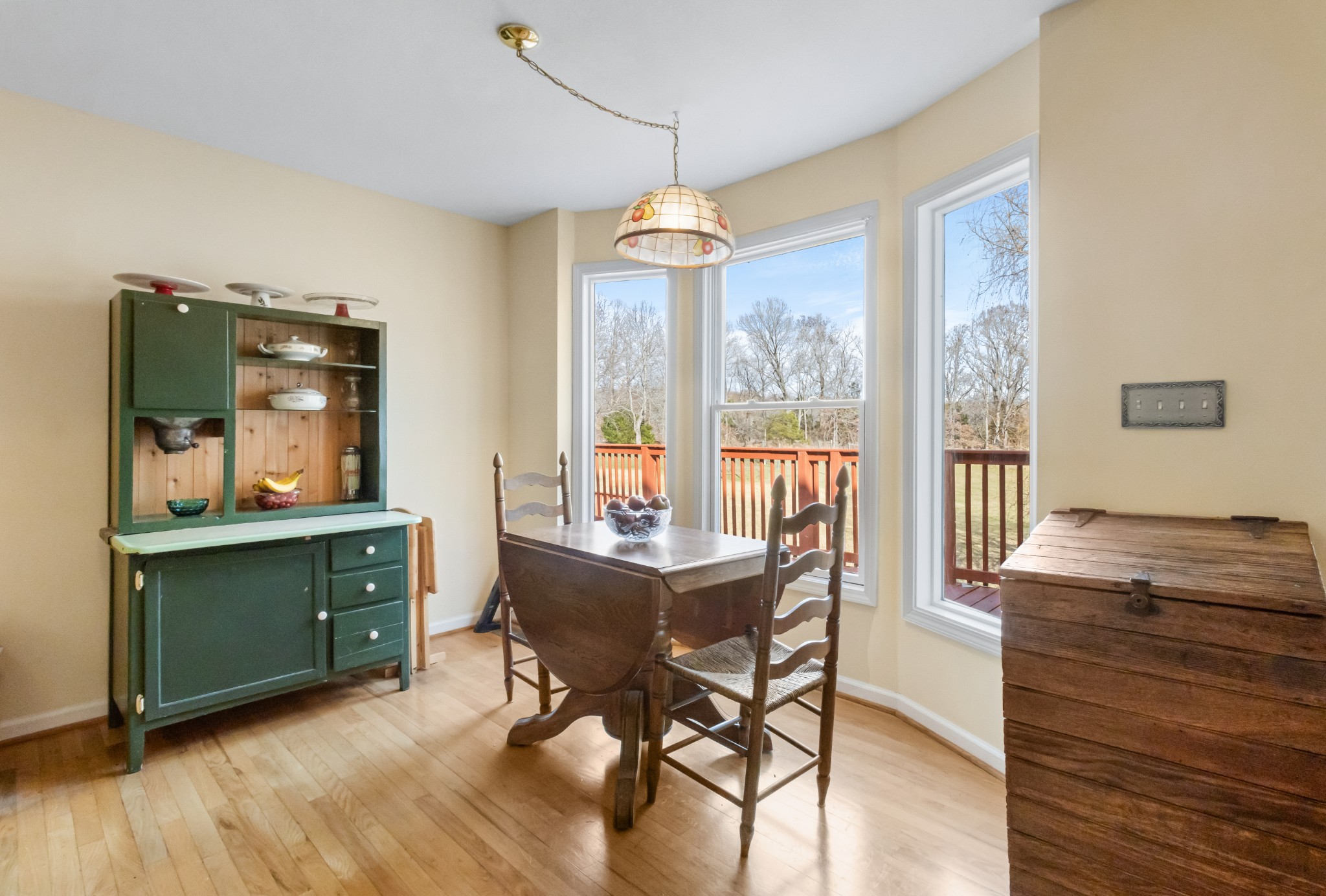 3710 Marthas Chapel Road Cunningham, TN 37052 - Photo 11 of 50 a dining room with wooden floor a chandelier a wooden table and chairs