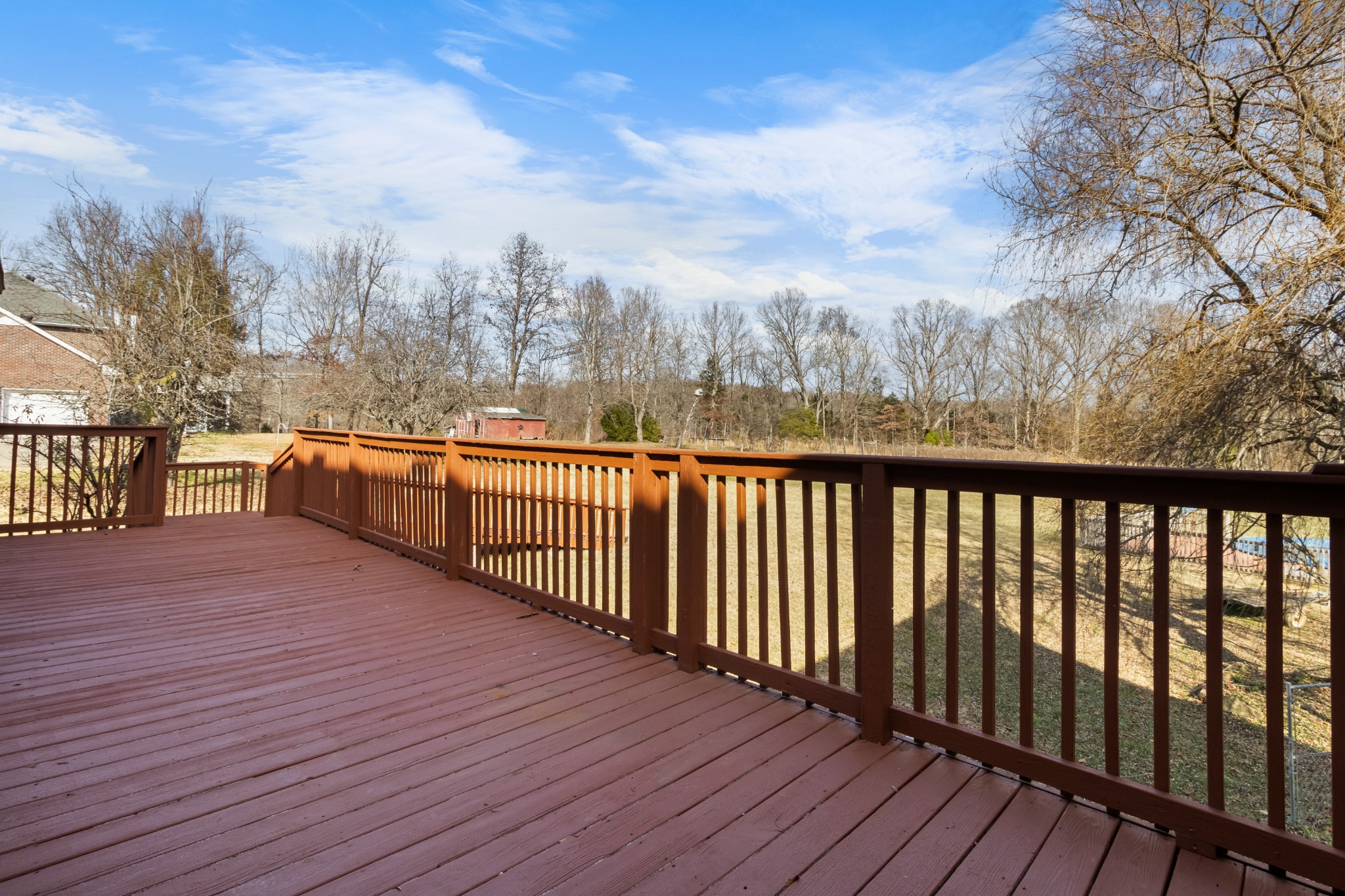 3710 Marthas Chapel Road Cunningham, TN 37052 - Photo 42 of 50 a view of a balcony with wooden floor and fence
