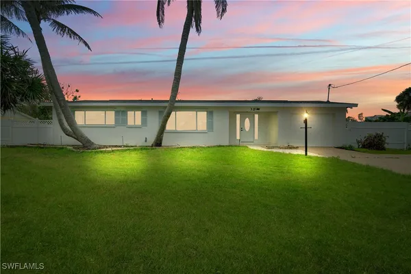 a house view with swimming pool and garden space